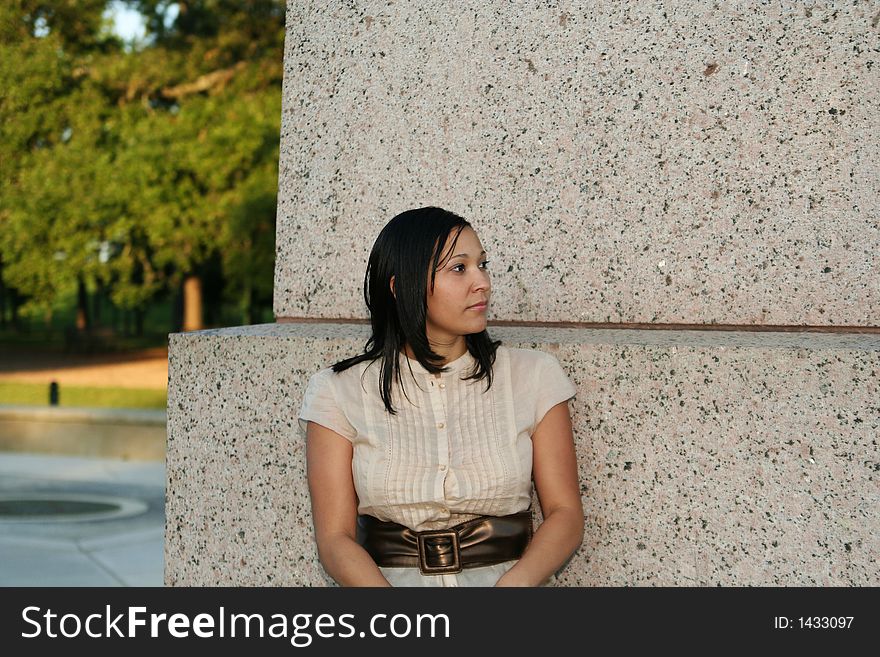 Lonely girl sitting and looking to her left. Lonely girl sitting and looking to her left