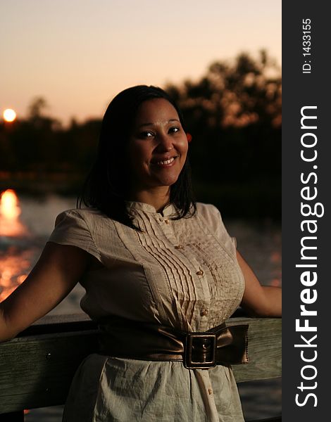 Beautiful girl posing on the bridge smiling. Beautiful girl posing on the bridge smiling