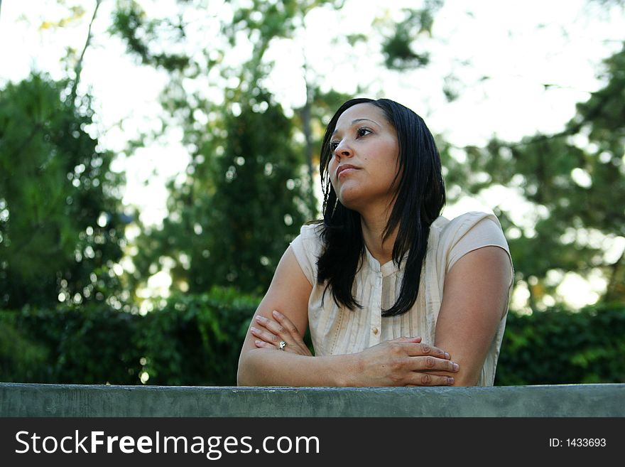 Beautiful girl standing behind a window and frustrated with tree background. Beautiful girl standing behind a window and frustrated with tree background