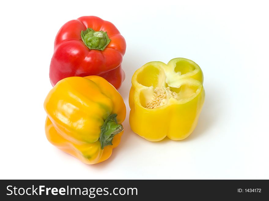 Red and yellow peppers, the yellow one is cut in the middle