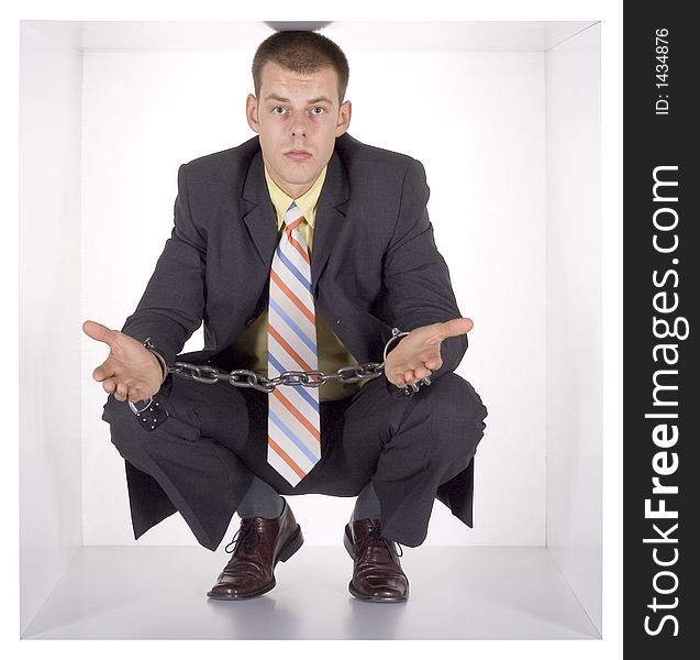 Chained businessman in the cube