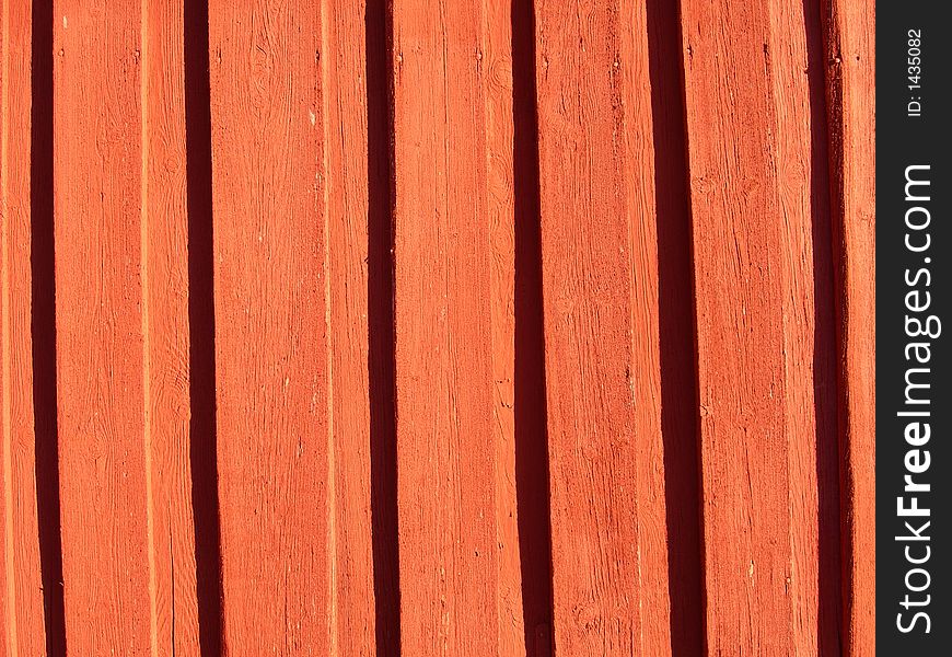 Red painted wall made of planks.