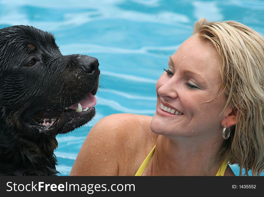 Model swimming with her rottweiler. Model swimming with her rottweiler