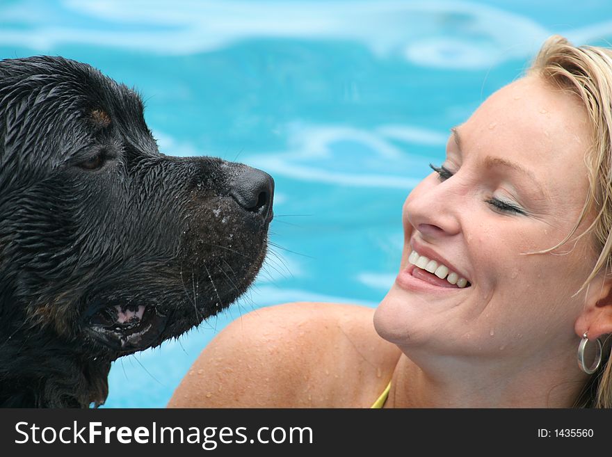 Model swimming with her rottweiler. Model swimming with her rottweiler