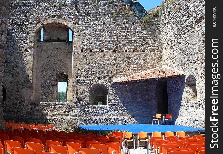 Theater box to the old castle with red chairs for the spectators