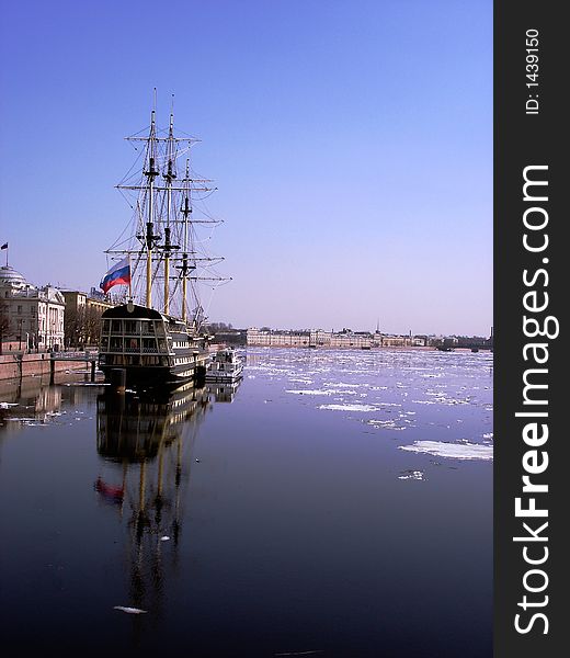 A three-mast ship under clear skies in the icy waters of the Neva river in St Petersburg