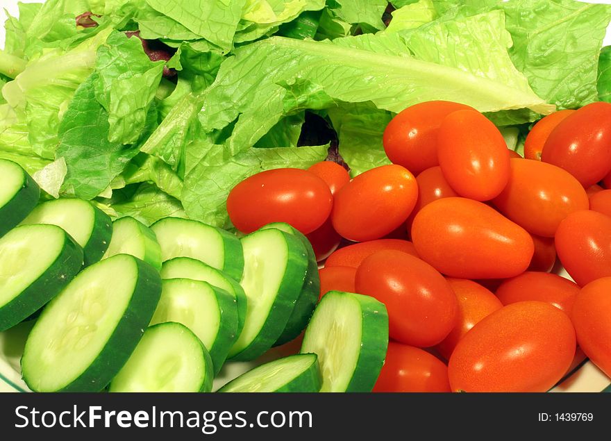 This is a close up image of the fresh vegetable ingredients for a salad. This is a close up image of the fresh vegetable ingredients for a salad.