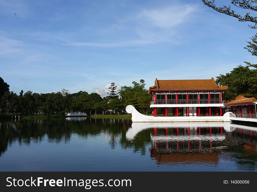 A beautiful stone boat with teahouse pavilion built above its deck sits on the lagoon at Chinese Garden