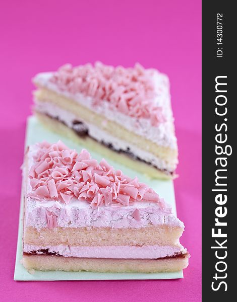 Freshly made cakes on pink background