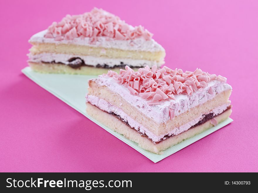 Freshly made cakes on pink background