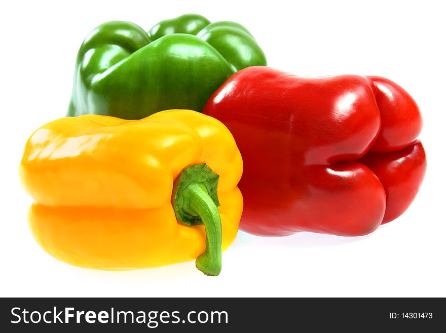 Red, yellow and green paprika on white background