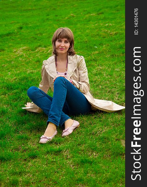 Woman sitting on green grass. Woman sitting on green grass