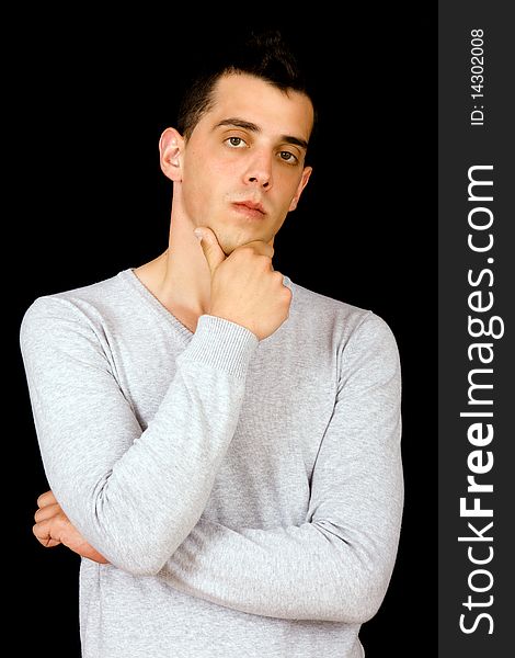 Portrait of a handsome young man on black background