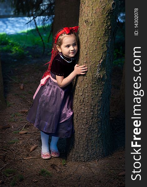 Snow white with apple, litle girl on a forest background