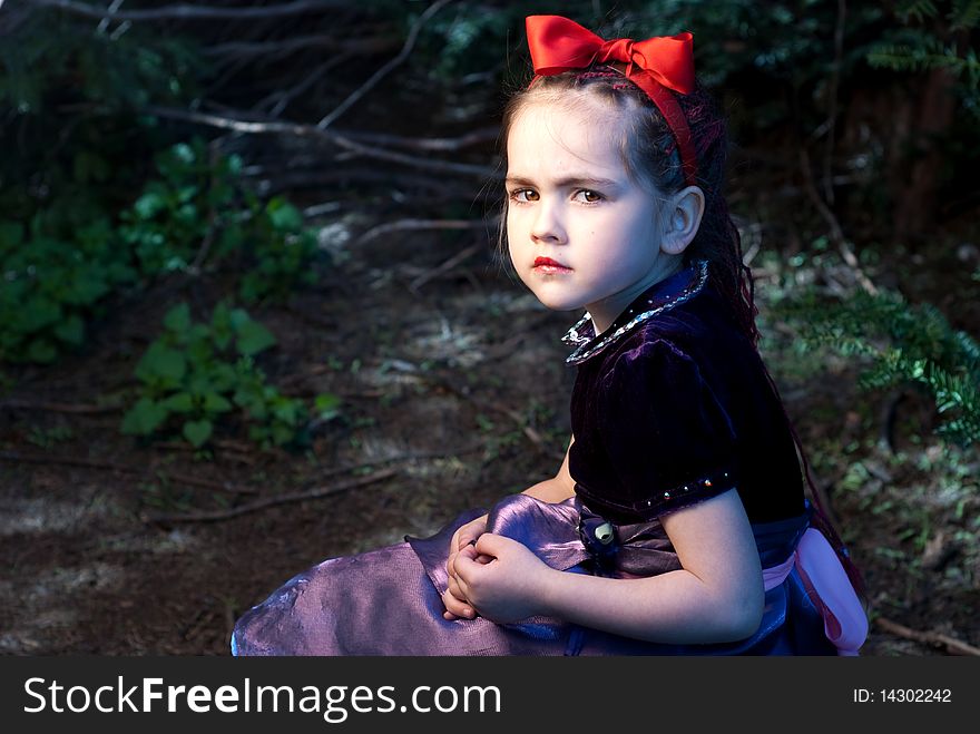 Snow white with apple, litle girl on a forest background