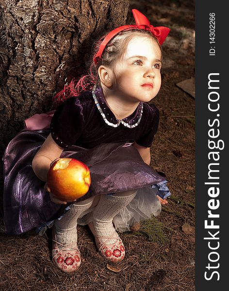 Snow white with apple, litle girl on a forest background