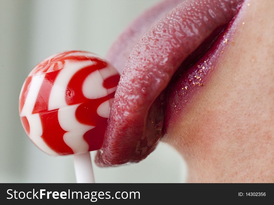 Close up view of some red lips with a lollipop. Close up view of some red lips with a lollipop.