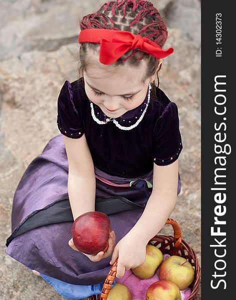 Snow white with apple, litle girl on a forest background