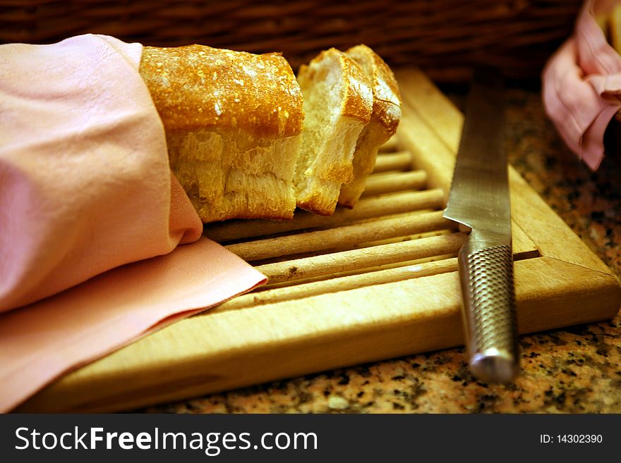 Slices of bread on chopping board with knife