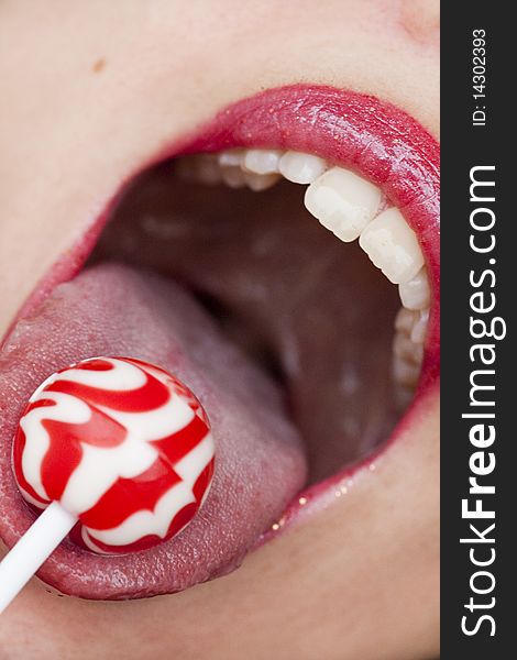 Close up view of some red lips with a lollipop. Close up view of some red lips with a lollipop.