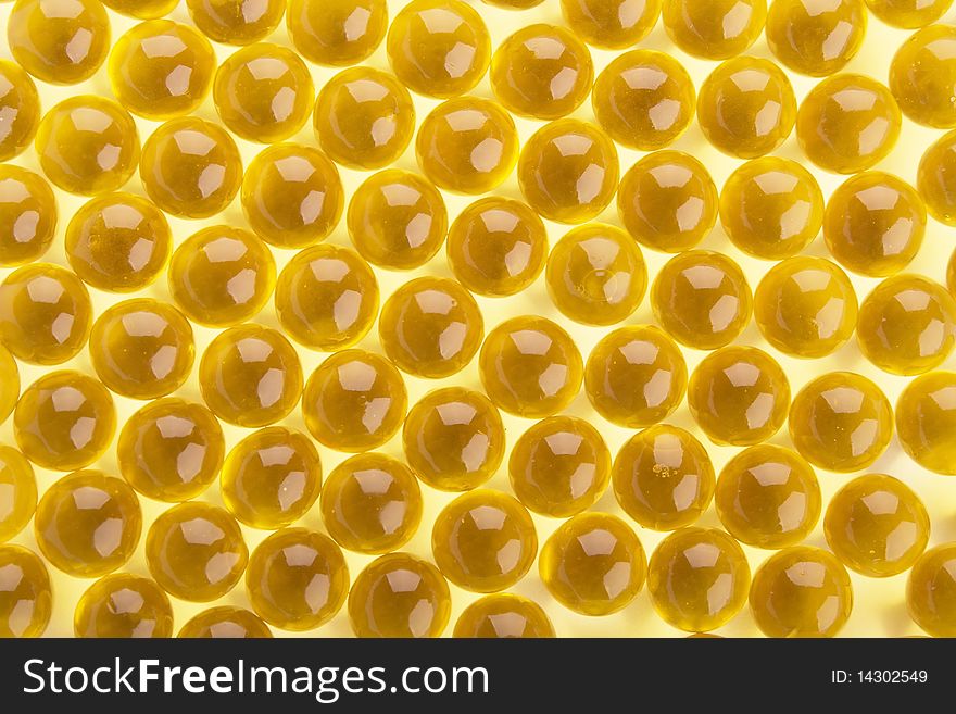 The abstract background from yellow  gel capsules. The abstract background from yellow  gel capsules