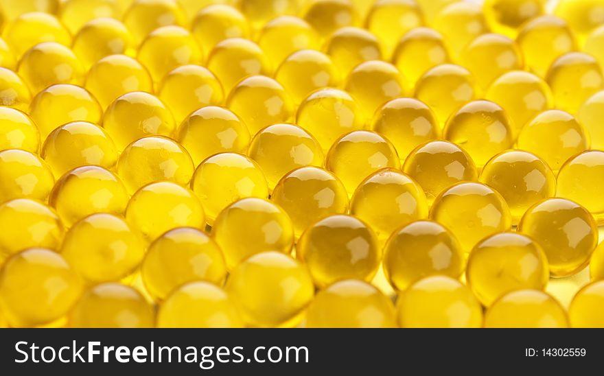 The abstract background from yellow  gel capsules. The abstract background from yellow  gel capsules