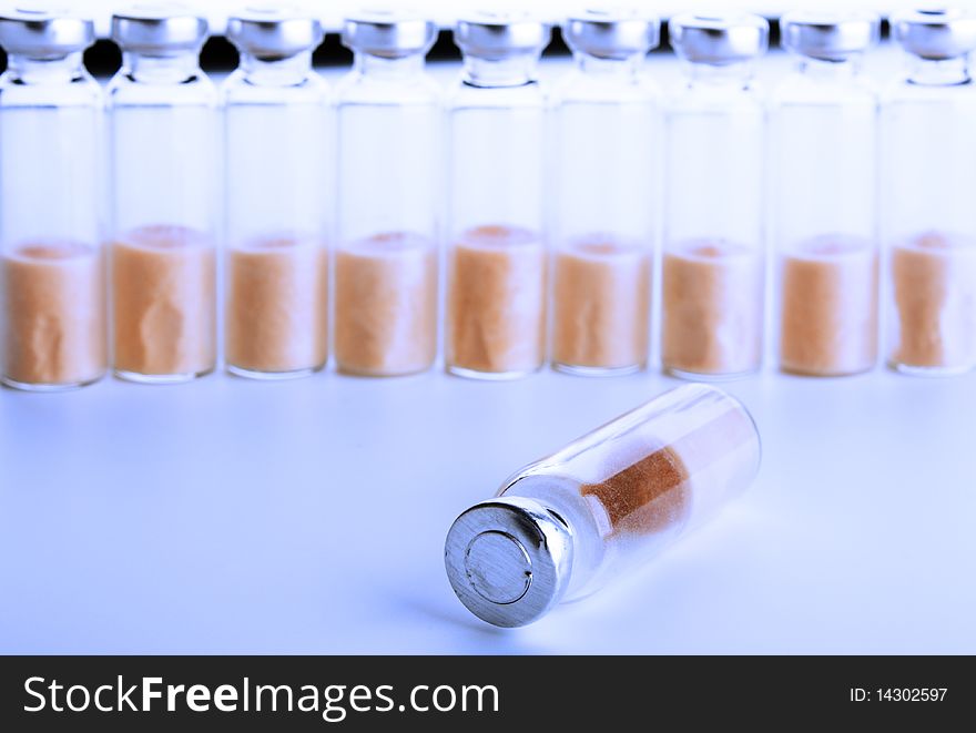 Sealed test tubes with bacteria stand beside, in blue light