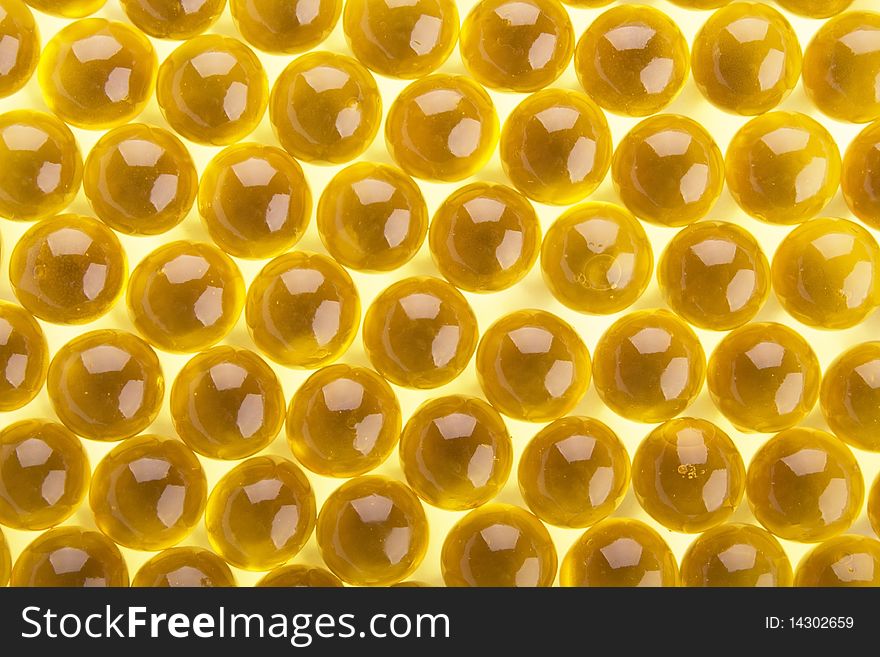 The abstract background from yellow  gel capsules. The abstract background from yellow  gel capsules