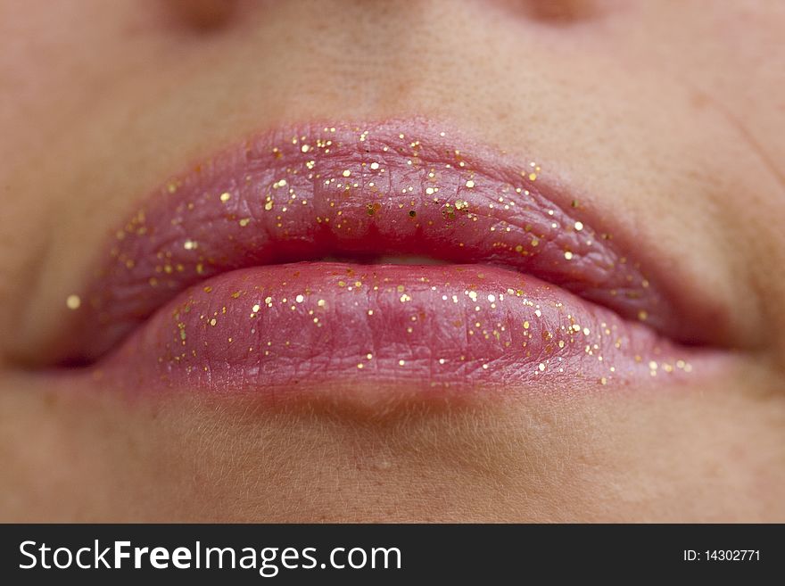 Close up view of some pink lips smiling.