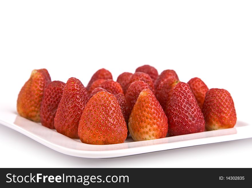 Strawberries on a plate isolated on white background
