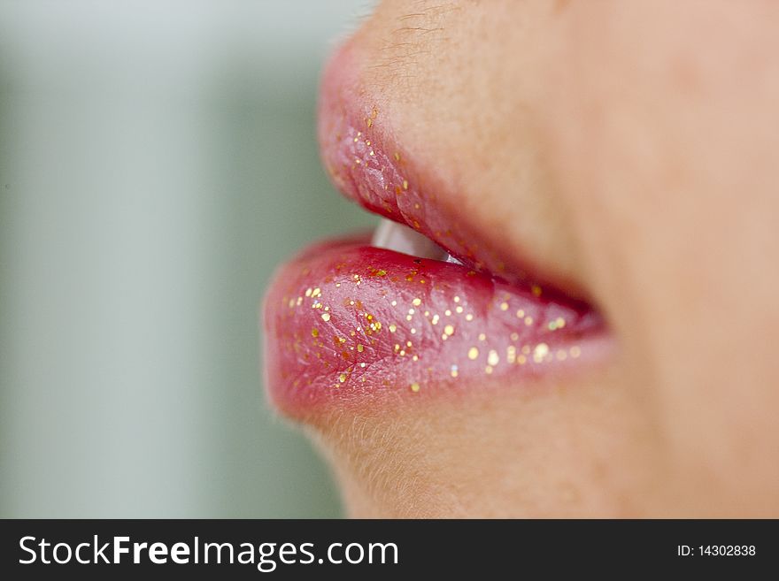 Close up view of some pink lips smiling.