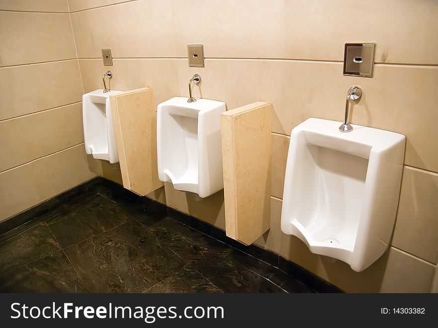 Row of  toilets in a man restroom