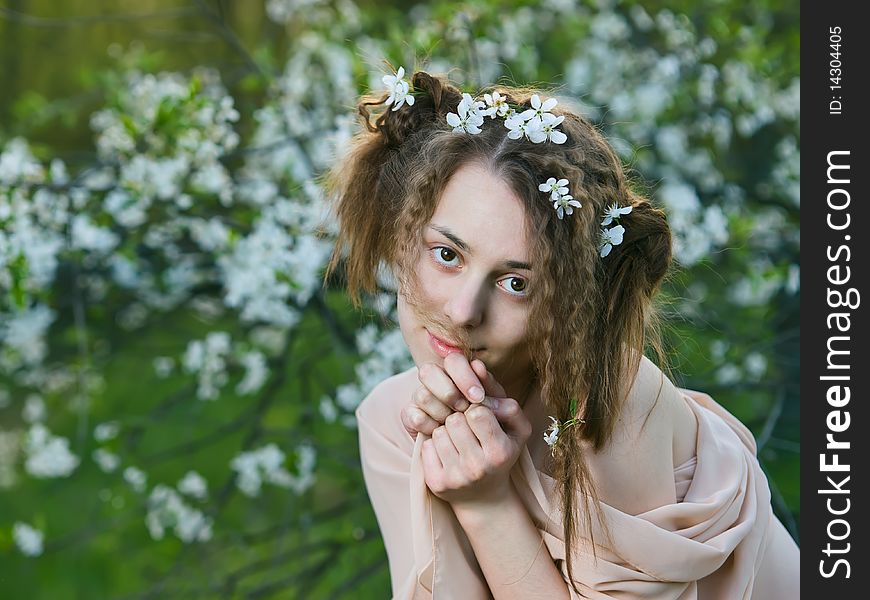 Outdoor portrait of beauty young girl with blossom on her hair. Outdoor portrait of beauty young girl with blossom on her hair