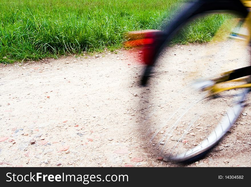 Riding bicycle on bike path, motion blur. Riding bicycle on bike path, motion blur
