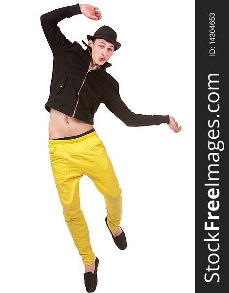 Stylish young man jumping in yellow pents