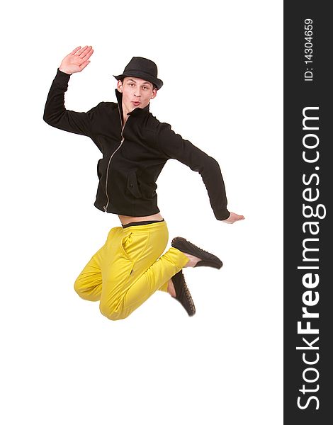 Stylish young man jumping in yellow pents