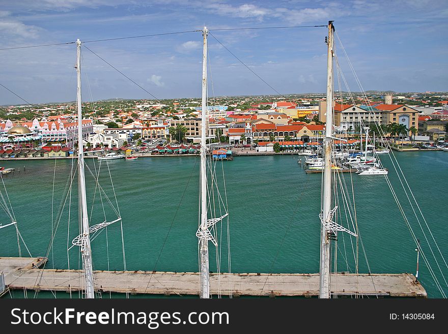 The harbor at Oranjestad, Aruba, seen through the masts of a yacht. The harbor at Oranjestad, Aruba, seen through the masts of a yacht