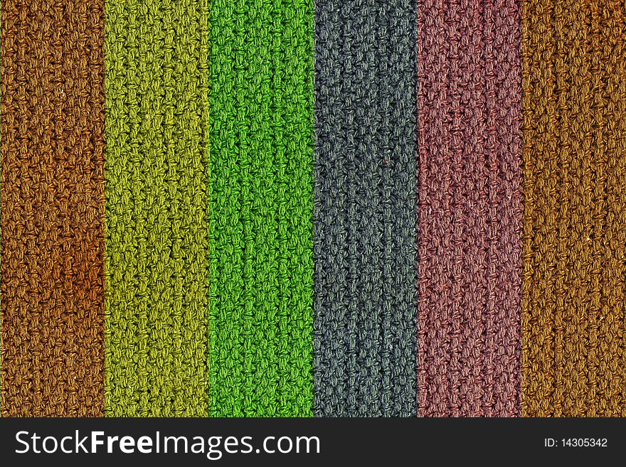 A texture background of a woven wool texture with vertical colored strips. A texture background of a woven wool texture with vertical colored strips.