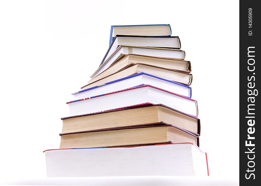 A lot of books, tower made of books against a white background. A lot of books, tower made of books against a white background