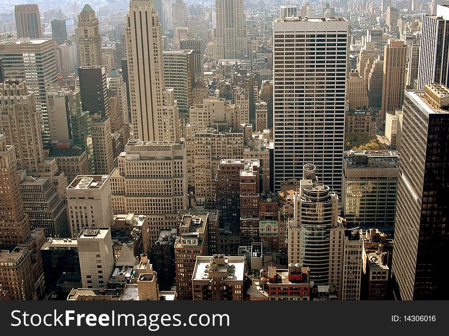 Densely packed office towers in midtown Manhattan in the East 40's seen from the 67th floor observation deck at 30 Rockefeller Center in New York City. Densely packed office towers in midtown Manhattan in the East 40's seen from the 67th floor observation deck at 30 Rockefeller Center in New York City.