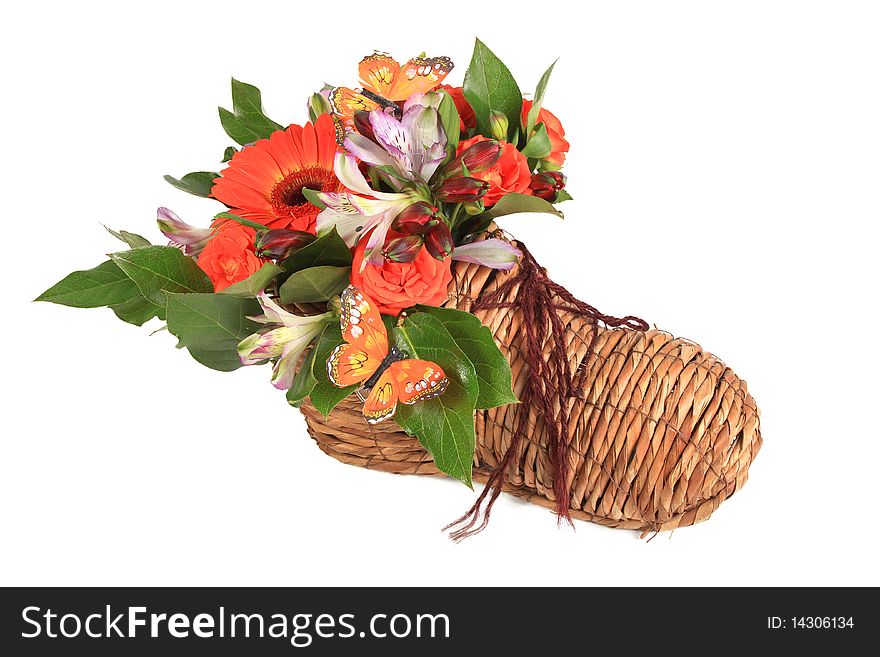 Bouquet of flowers in shoe on white background