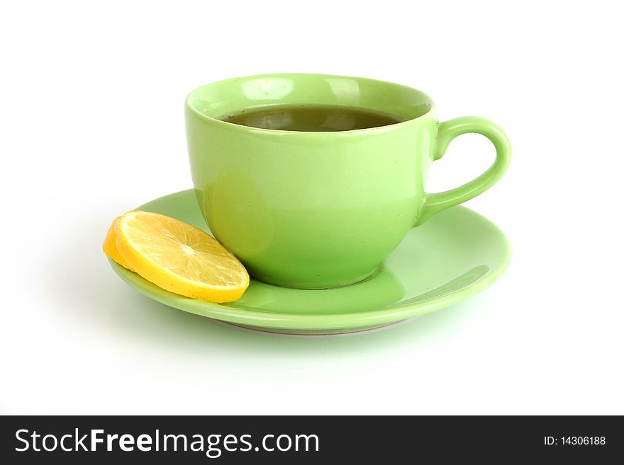 Cup of tea with lemons and lumps of sugar on white background