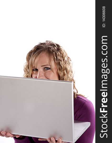 A woman is peeking over the top of a laptop computer. A woman is peeking over the top of a laptop computer.