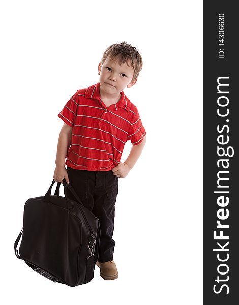 A very young boy has a black bag and looking. A very young boy has a black bag and looking.