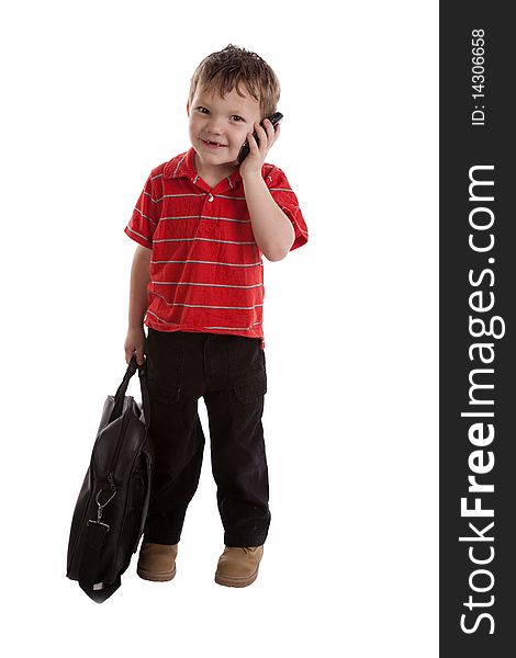 A young boy is smiling and talking on the phone. A young boy is smiling and talking on the phone