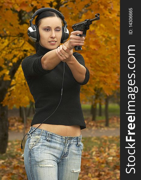 Girl  Brunette In  Headphones With  Pistol