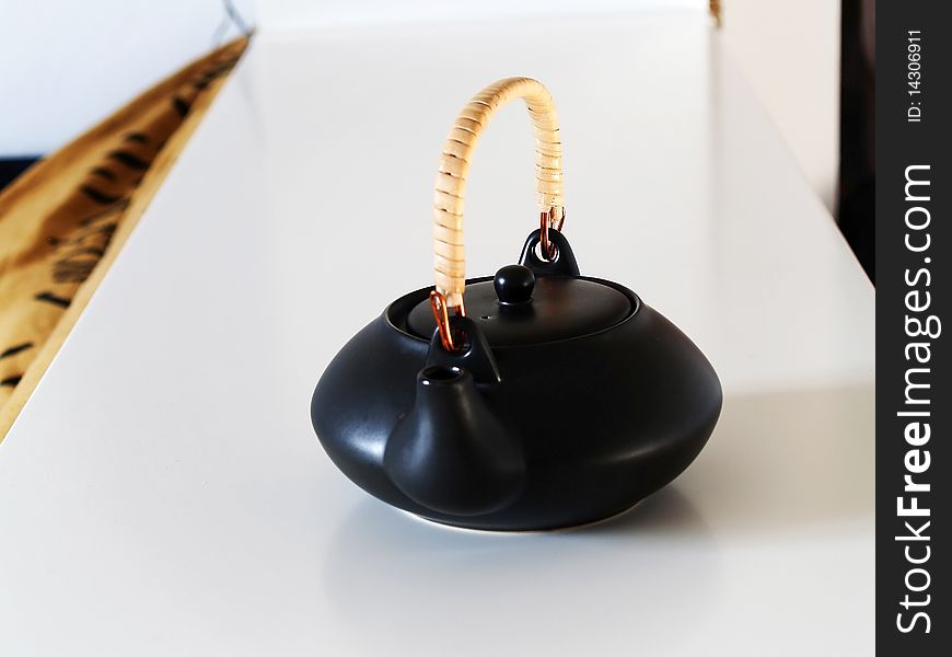 Black ceramic teapot on a tray. Black ceramic teapot on a tray