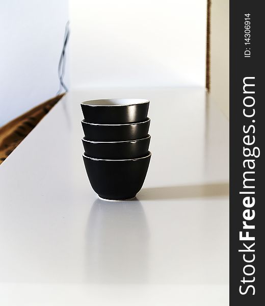 black ceramic coffee cups stacked