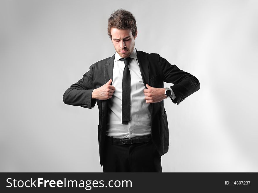 Young businessman adjusting his jacket