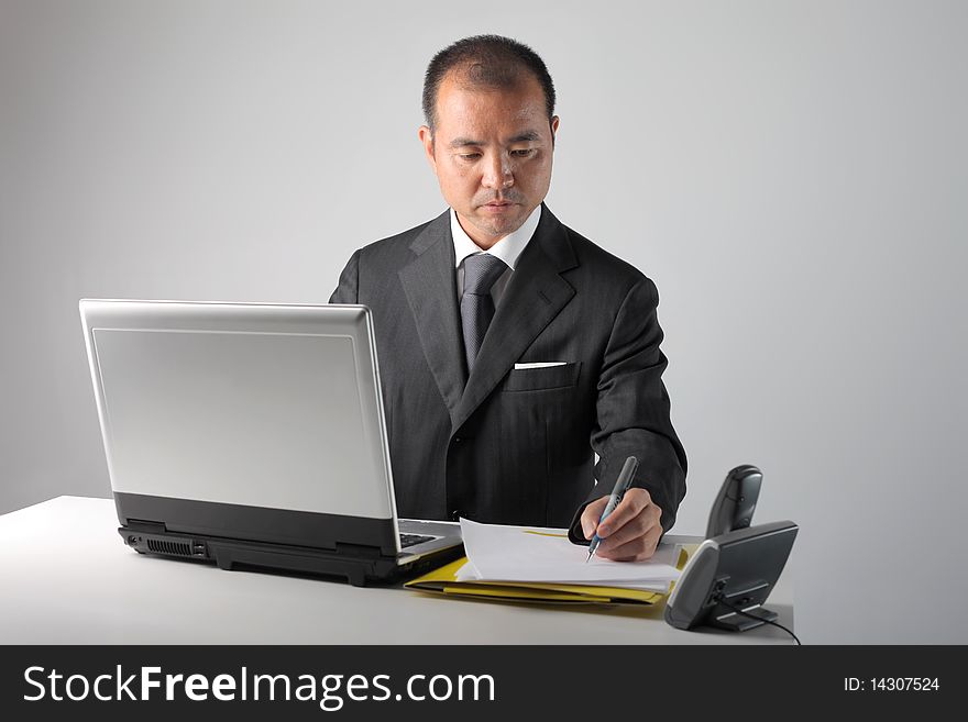 Japanese businessman working in front of a laptop